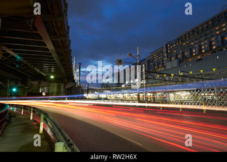 Kyoto Station underpass during blue hours with  light traces from the passing cars. Traffic light with light streams from ongoing traffic Stock Photo