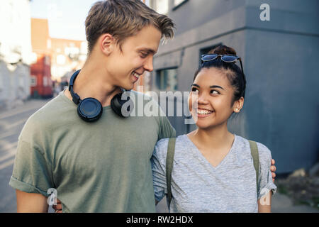 Smiling young couple standing together in the city Stock Photo
