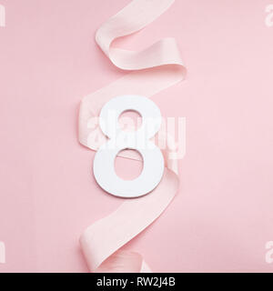 Happy International Womens Day celebrate on eight March. Number eight on pink background Stock Photo