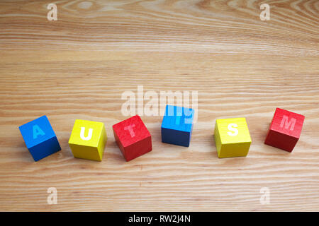 concept of autism word on colored wooden cubes Stock Photo