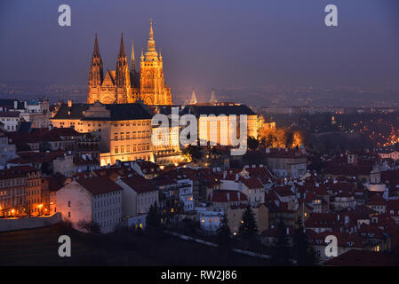 he Prague Castle and the St. Vitus Cathedral with night illumination. Fragment of the Lesser Town district (Czech: Malá Strana). Late evening. Winter.