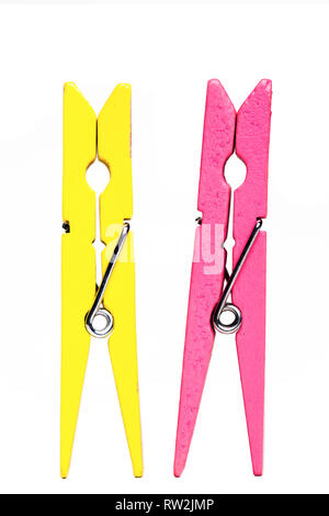 yellow and pink clothes pegs isolated on white background Stock Photo