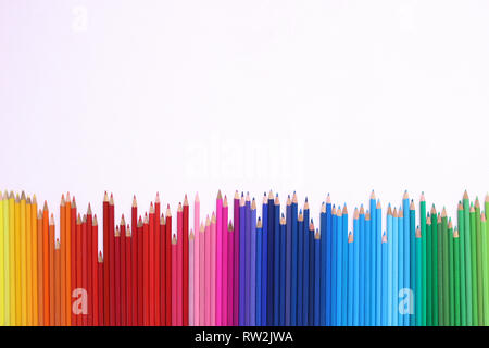 Rainbow Pencils. A row of coloured pencils on a white background Stock Photo