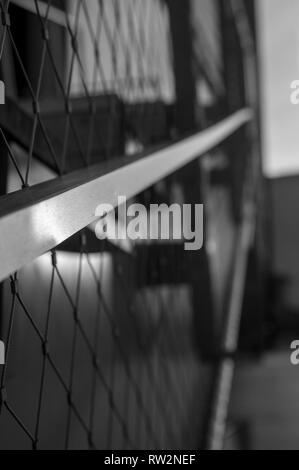 Black and White Macro Shot of an outdoor metal railing with light reflecting off its surfaces Stock Photo