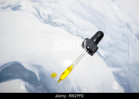 Glass dropper with essential oil. Stock Photo