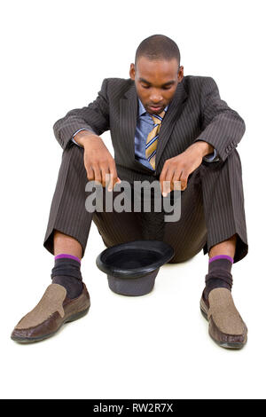 young depressed black businessman sitting in a corner Stock Photo