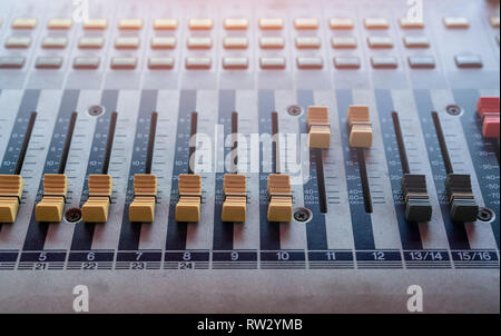 Audio sound mixer console. Sound mixing desk. Music mixer control panel in recording studio. Audio mixing console with faders and adjusting knob. Stock Photo