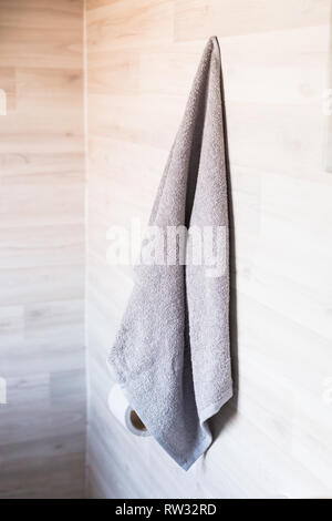 Clean towel is hanging on the wall in the bathroom. Stock Photo