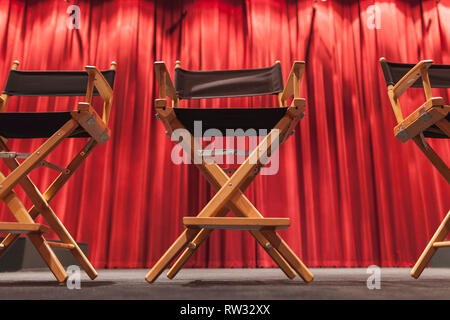 Director chairs against a curtain movie stage background at the school of visual arts theater in New York City, New York, USA. Stock Photo