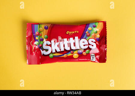 Ukraine, Kiev March 29, 2018.   Closeup of Skittles candy made by Wm. Wrigley Jr. Company on yellow background Stock Photo