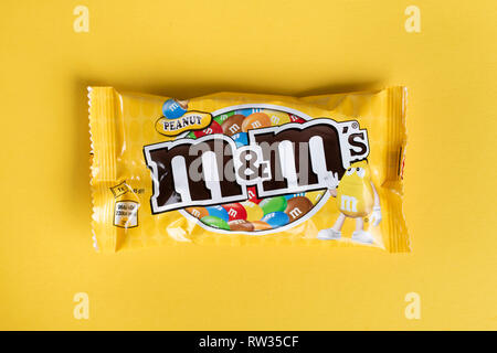 Ukraine, Kiev March 29, 2018.  Closeup of  M&M's milk chocolate candies made by Mars Inc. on yellow background Stock Photo