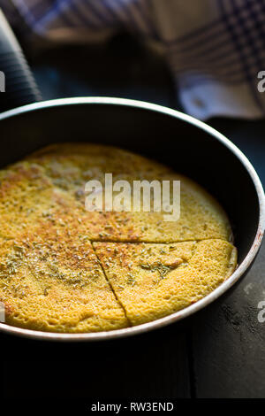 Sliced Vegan Chickpea Omelette On a Frying Pan Stock Photo