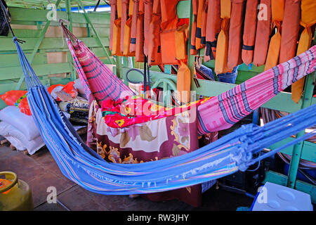 Hammocks on passengers deck on cattle pontoon boat on Rio Paraguay river, Corumba, Pantanal, Mato Grosso, Brazil Stock Photo