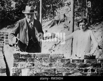 Winston Churchill with his daughter, Sarah, laying bricks at Chartwell. September 1928. Stock Photo