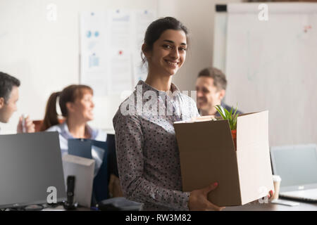 Portrait of new indian female employee or intern holding cardboard box Stock Photo
