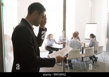 Nervous stressed sweaty businessman speaker feel public speaking fear Stock Photo