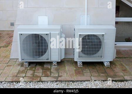 Two air conditioning units outside a house Stock Photo