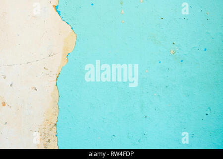 Peeling Blue Aquamarine Color Paint from the Wall. Shattered Plaster Background Stock Photo