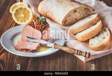 Chicken liver pate with ciabatta on the white plate Stock Photo