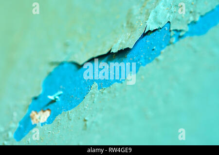 Peeling Blue Aquamarine Color Paint from the Wall. Shattered Plaster Background Stock Photo