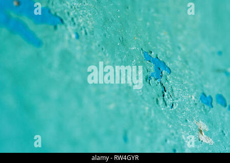 Peeling Blue Aquamarine Color Paint from the Wall. Shattered Plaster Background Stock Photo