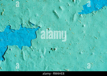 Peeling Blue Aquamarine Color Paint from the Wall. Shattered Plaster Background Stock Photo