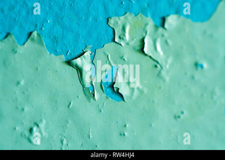 Peeling Blue Aquamarine Color Paint from the Wall. Shattered Plaster Background Stock Photo