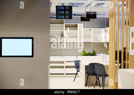 The center of paperwork. Co-working process, the design team operates a modern office. Desktop computers on a wooden table. Blurred background Stock Photo