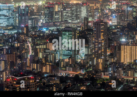 Tokyo - August 08, 2017 : Tokyo skyline night aerial view High Rise Buildings and highway car trails from Roppongi Hills Mori Tower. Stock Photo