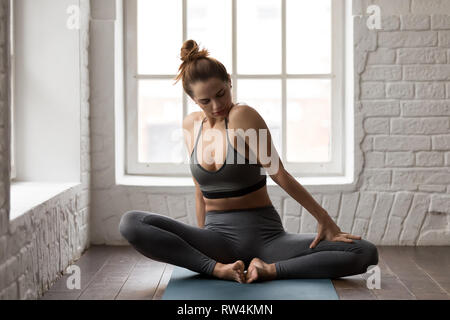 Young woman practicing yoga, sitting in Butterfly pose, baddha konasana Stock Photo