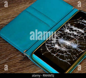 Cracked smartphone screen. Broken mobile phone. Stock Photo