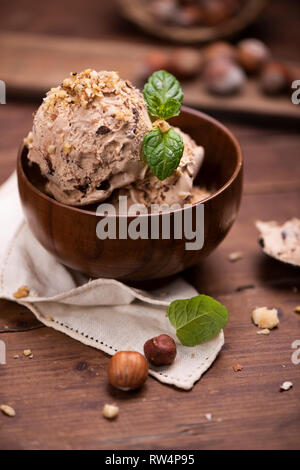 Fresh hazelnut ice cream on wooden plate close up Stock Photo