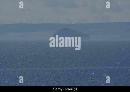 Bass Rock beyond s Sparkling Summer Sea on a Hazy Day. Fife, Scotland, UK. Stock Photo