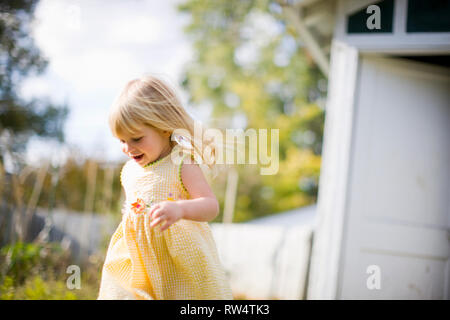 Little girl running outside Stock Photo