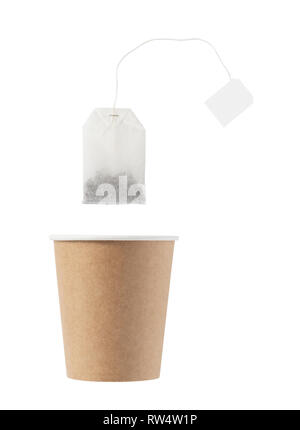 Paper disposable cup with tea bag on a white background. Stock Photo