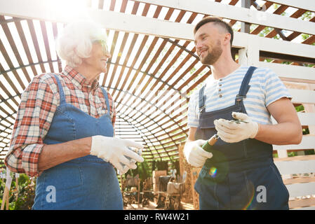 Two Smiling Gardeners in Sunlight Stock Photo