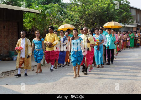 Guests of a Cambodian wedding walk on the street Stock Photo