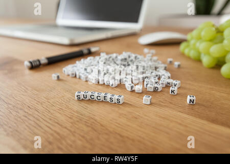 Success word written on cube shape white blocks on wooden Busine Stock Photo