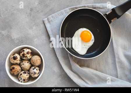 Quail egg fried in a pan. Fresh organic egg. Stock Photo