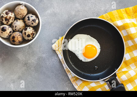 Quail egg fried in a pan. Fresh organic egg. Stock Photo