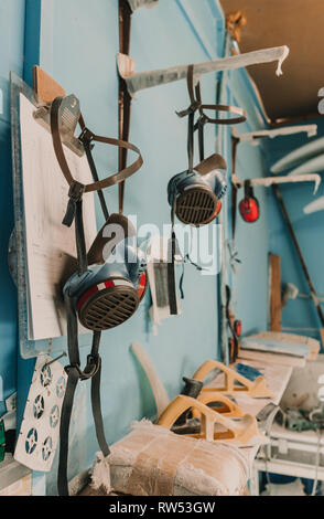 Breathers hanging near carpenter planes and other tools on workplace Stock Photo