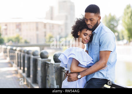 Loving young couple enjoying tender moment outdoors Stock Photo