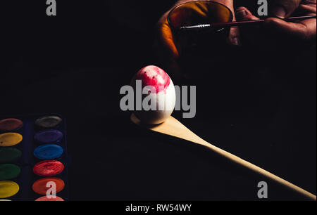 Crop hand painting Easter egg Stock Photo