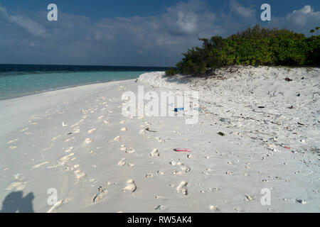 plastic and rubbish on desert tropical island paradise sandy beach Stock Photo