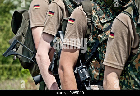Squad of german soldiers holding machine guns. Stock Photo
