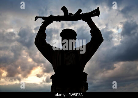 Silhouette of muslim militant with rifle. Stock Photo