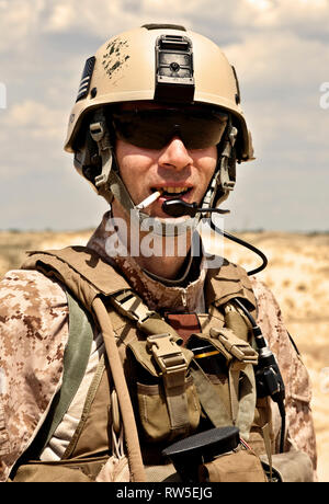 Smiling U.S. soldier smoking a cigarette Stock Photo