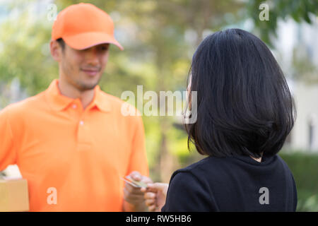 Woman is using credit card to pay for online delivery Stock Photo