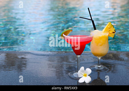 Strawberry daiquiri and pina colada on the pool background, selective focus. Tropical holidays Stock Photo