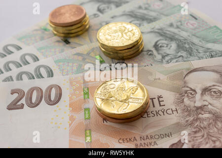 Czech coin on the various Czech banknotes money like background. Hundred crowns, two hundred crowns, twenty crowns coins Stock Photo
